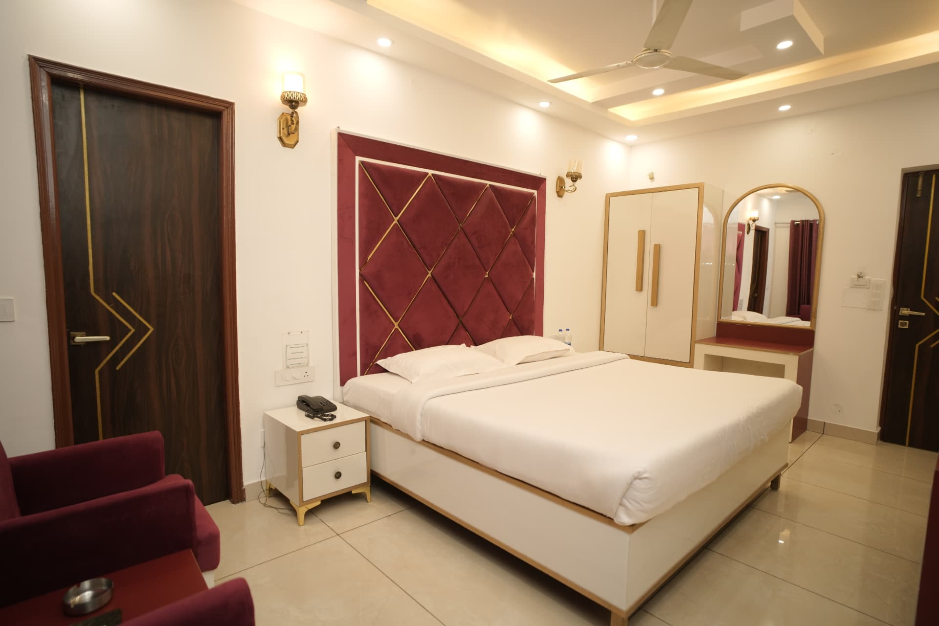 Deluxe Room with a maroon diamond-pattern headboard
