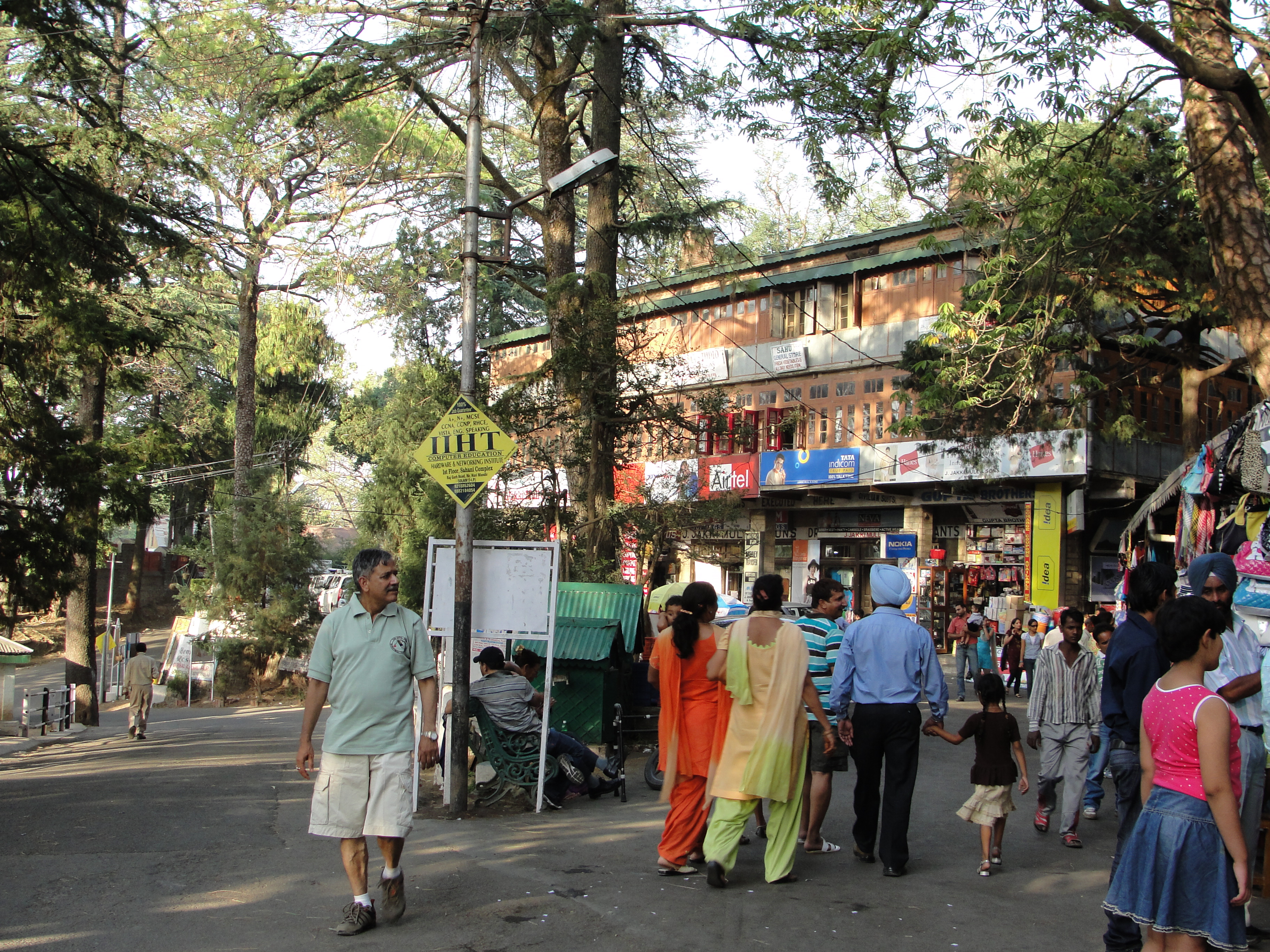 Visitors and shops on tree-lined Lower Mall Road in Kasauli